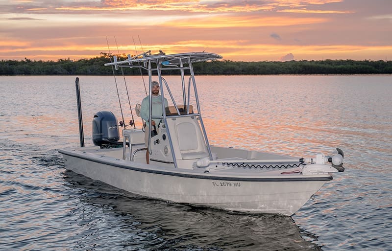 Captain Drew on his boat at sunset