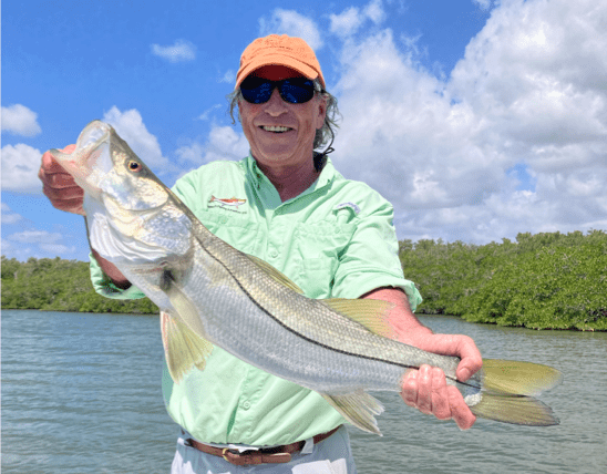 Adult male posing with fish