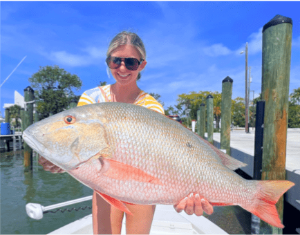 Woman holding a Mutton Snapper
