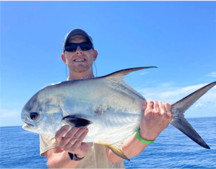 Man posing with a Permit fish