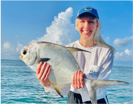 Woman posing with a Permit fish